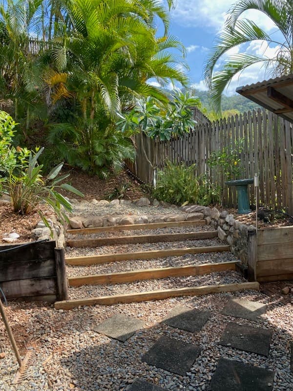 Timber sleeper steps and gravel terracing a steep planted garden