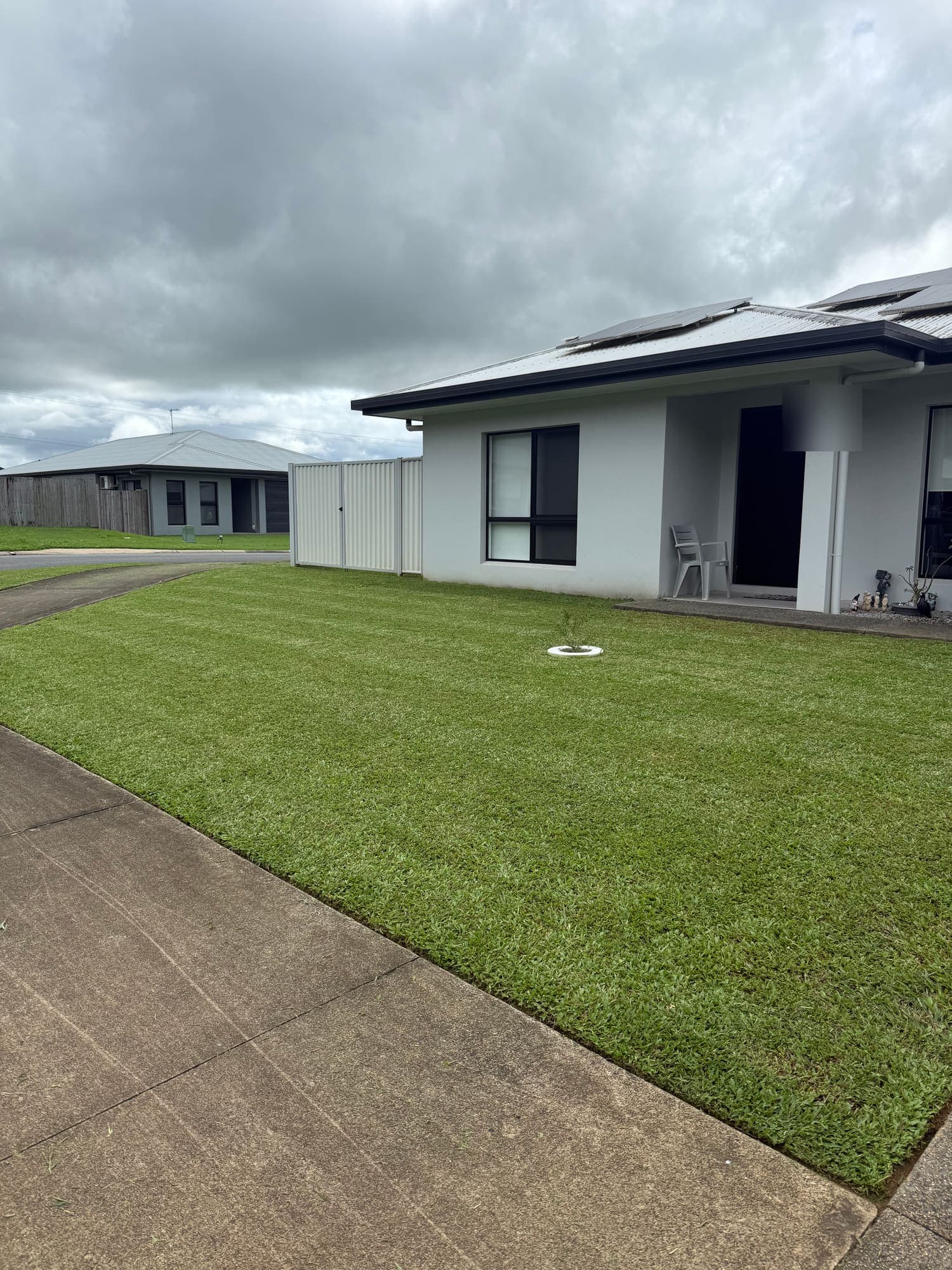 Mown front lawn and clean edges at a modern Cairns home